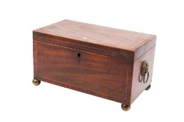 George III mahogany and string inlaid tea caddy. Having lion mask handles and ball feet.