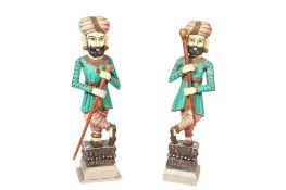 A pair of 20th century carved wooden Rajasthan floor standing polychrome decorated Darban