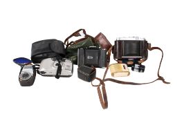 A group of three assorted film cameras.