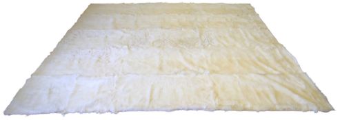 A large white goat fur rug.
