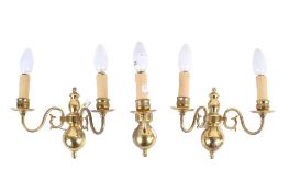 A set of three brass wall lights.