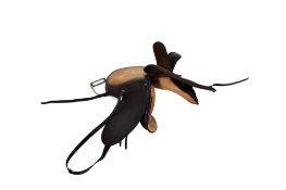 An antique leather horse riding side saddle with stirrup.