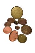 A quantity of assorted copper and brassware items mostly chargers. Of various styles and sizes. Max.