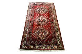 A 20th century Persian style red rug.