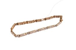 A 9ct gold panel bracelet set with cubic zirconia in rows and crosses.