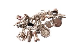 A silver charm bracelet with a heart padlock.