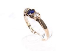 A hallmarked 9ct gold dress ring set with blue and white synthetic stones. Size N, gross weight 1.