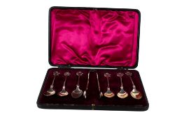 A set of silver teaspoons and sugar tongs.