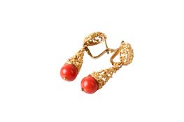 A pair of drop earrings, each with a coral bead termination.