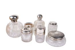 Seven silver topped glass dressing table jars and bottles.