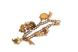 A 9ct gold charm bracelet with a pendant 1911 half sovereign coin.