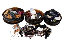 Three baskets of costume jewellery and sewing accessories.