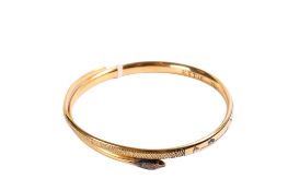 A gold snake bangle.