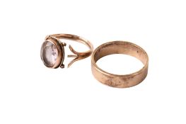 A 9ct gold wedding band and a rose coloured metal and amethyst ring.