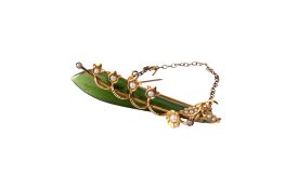 A 9ct gold and dark green nephrite brooch.