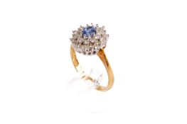 An 18ct gold, blue and white stone cluster ring.