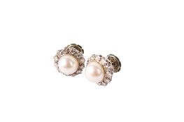 A pair of pearl and diamond cluster earrings. Each set centrally with a cultured pearl of 8.