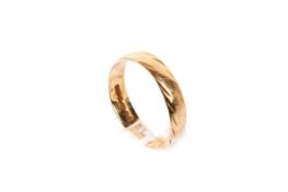 An 18ct gold wedding band. With engraved lineal decoration, hallmarked, size O-O1/2, weight 3.2g.