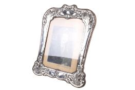 An Art Nouveau silver fronted photograph frame.
