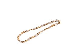 A 9ct gold (tested) bi-colour panel bracelet. Set with single cut diamonds of 0.