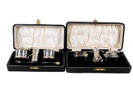 Two cased silver cruet sets.