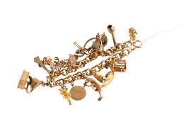A double curb link bracelet with sixteen charms attached and one loose.