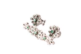 An 18ct white gold (tested) and emerald brooch and earrings set.