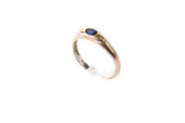 A yellow metal, sapphire and diamond three stone ring.
