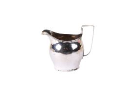 A Georgian silver cream jug. Simple banding to the rim, undecorated, the base gently splayed.