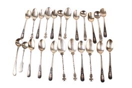 An assortment of silver and white metal teaspoons.
