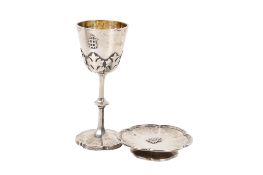 A Victorian silver travelling communion goblet and a footed paten.