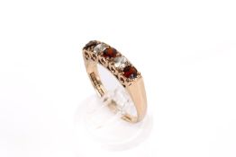 A 9ct gold ring set with synthetic spinel and garnet. Hallmarked, size O, gross weight 2.7g.