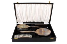 A 20th century silver backed brush set.