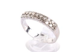 An 18ct white gold (tested) and diamond dress ring. Set with round brilliant cut diamonds of 0.
