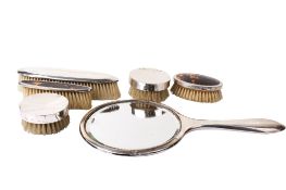 An assortment of silver backed dressing table accessories.