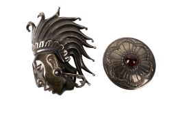 A silver pendant and a Mexican silver and stone brooch.