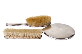 A George V silver three-piece dressing table set.