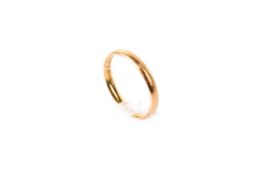 A 22ct gold wedding band. Of narrow form, width 2mm, size R, weight 3.5g.