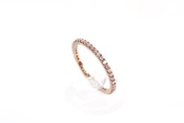 A 9ct gold and diamond full eternity band. Set with small round cut diamonds of circa 1.
