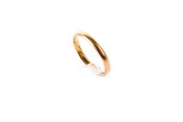 A 22ct gold wedding band. Of narrow form, hallmarked, W2mm, size K1/2, weight 2.2g.