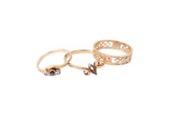 Three 9ct gold and yellow metal rings.