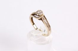 A hallmarked 9ct gold and diamond dress ring. Set with mixed round cut diamonds of 0.