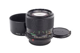 A Canon FD 85mm f1.8 lens. Serial number 82328. With front and rear caps, and Canon BT-52 hood.