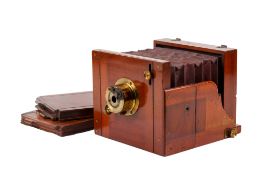 An Unbranded Antique Tailboard camera. Possibly Marion & Co. Brass and Mahogany construction.