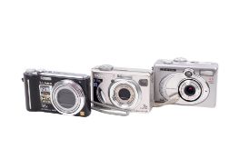 Three digital compact cameras.