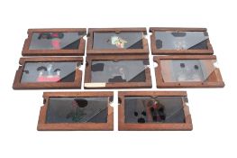 Eight wood-framed hand-coloured double-slipper animated moving Magic Lantern Slides.