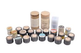 A collection of instructional and educational film strips in canisters.