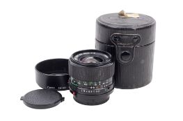 A Canon FD 35mm f2 lens. Serial number 21481. With front and rear caps, and Canon BW-52A hood.