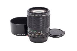 A Canon FD 100mm f2 lens. Serial number 35307. With front and rear caps, and Canon BT-52 hood.