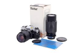 An Olympus OM10 35mm SLR camera outfit. Chrome. Serial number 2142327.